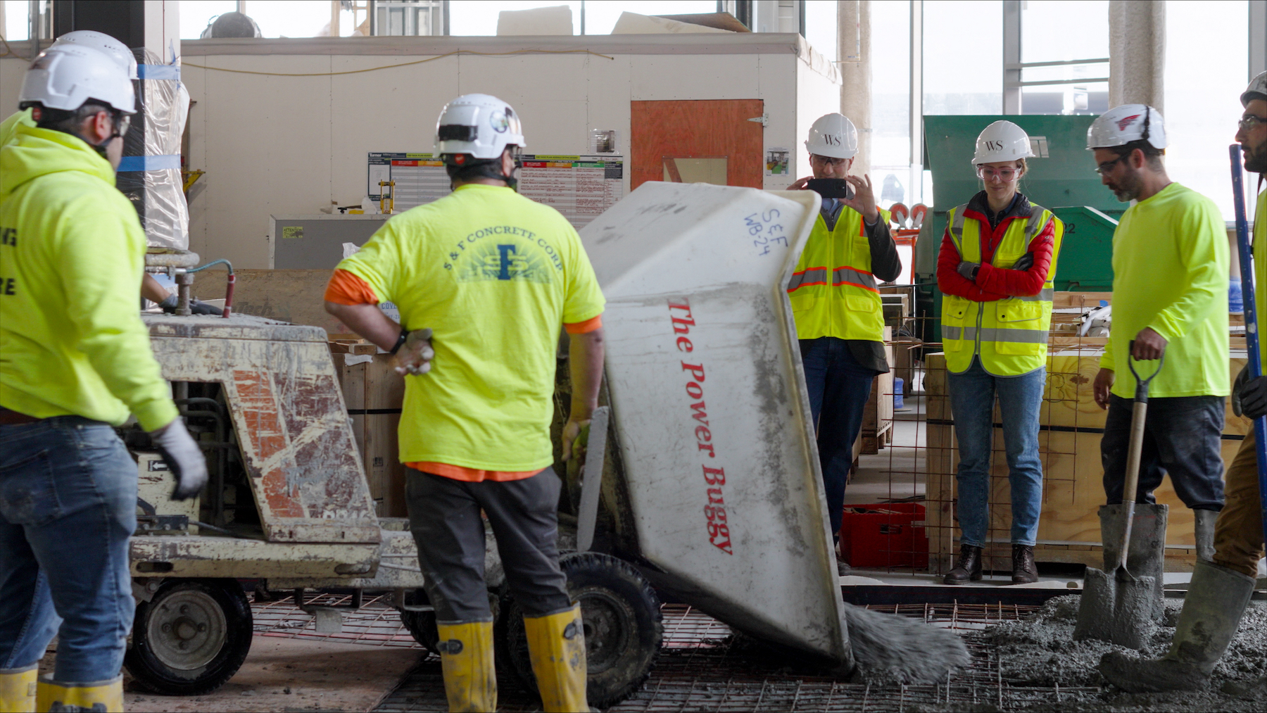 Crews pouring concrete produced with low-carbon technology