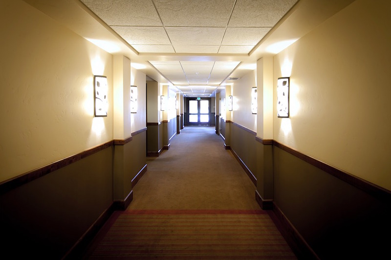 Rooms lining a hotel hallway