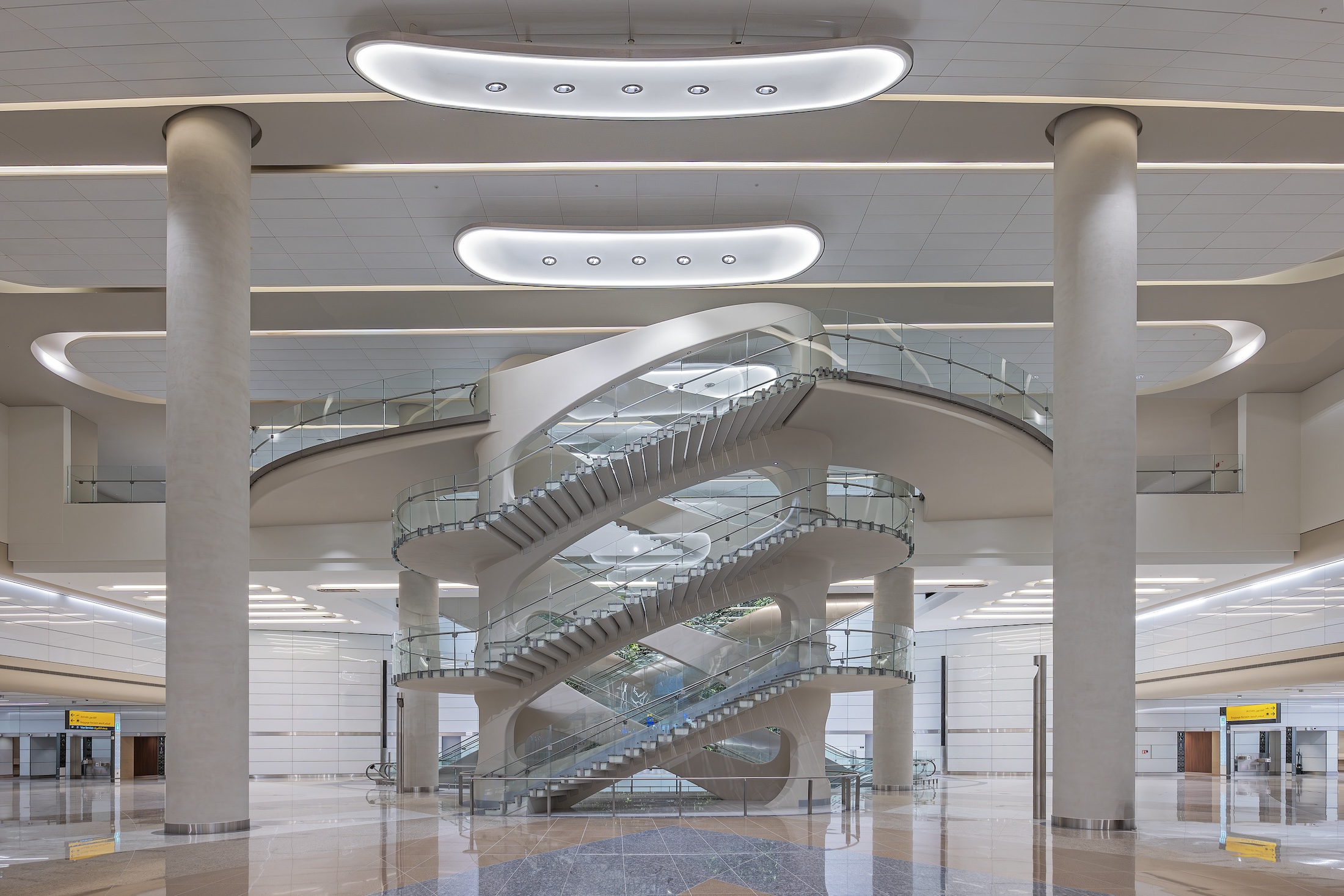View of the Arrivals Hall Feature Staircase at Zayed International Airport, Terminal A. Photo: Victor Romero, courtesy Kohn Pedersen Fox (KPF)