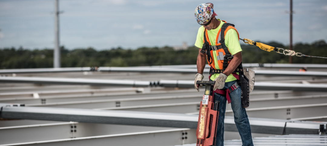A Barton Malow construction worker installs a metal roof deck.