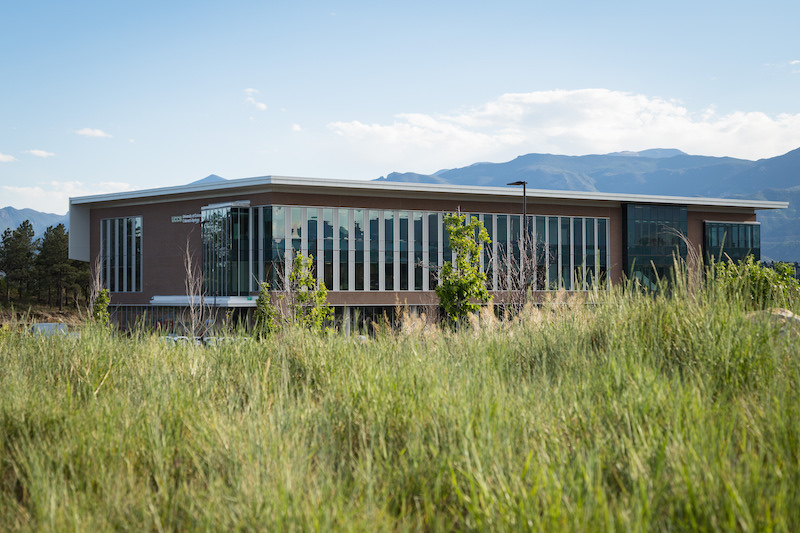 William J. Hybl Sports Medicine and Performance Center against a backdrop of mountains