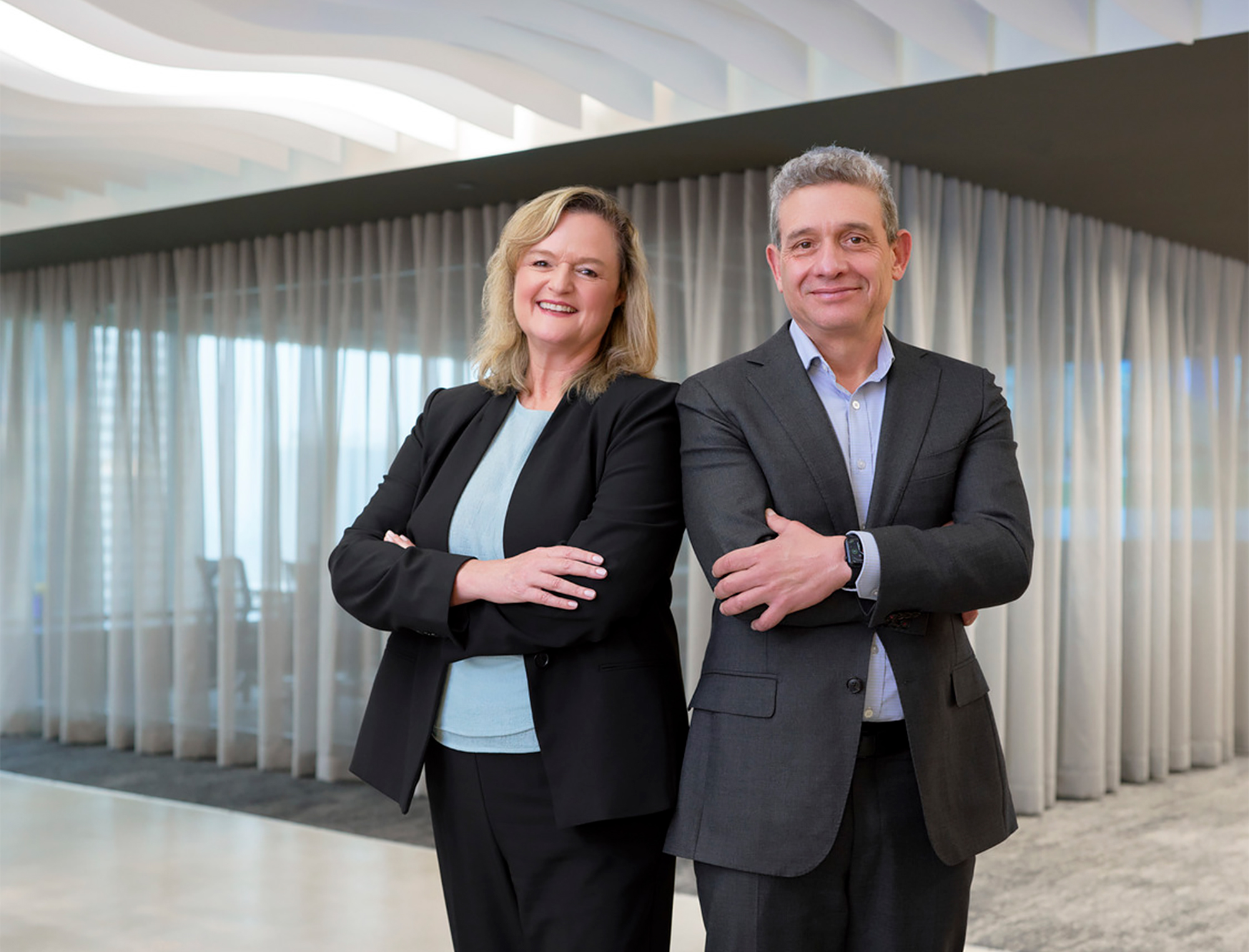 Co-CEOs headshot in modern building