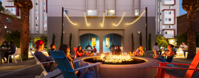 Students sit around a fire at a campus student center
