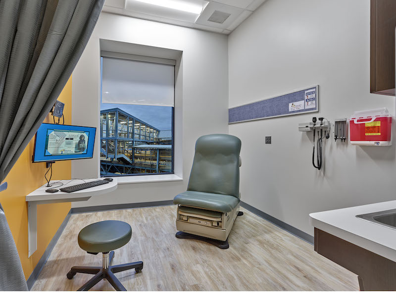 One of the clinic's exam rooms, from which can be seen the elevated subway platform outside.