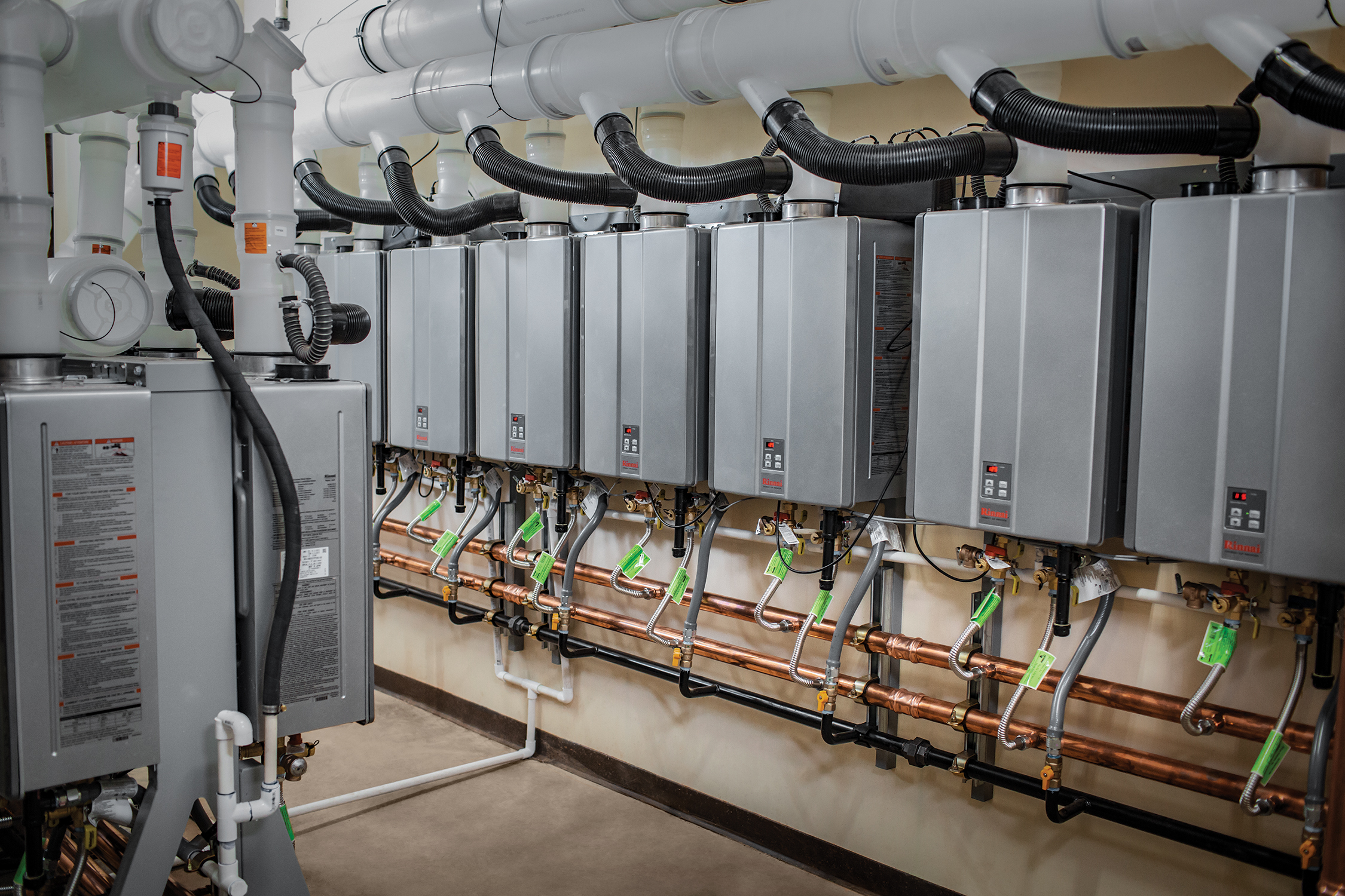 Multiple propane tankless water heaters installed in an apartment building.