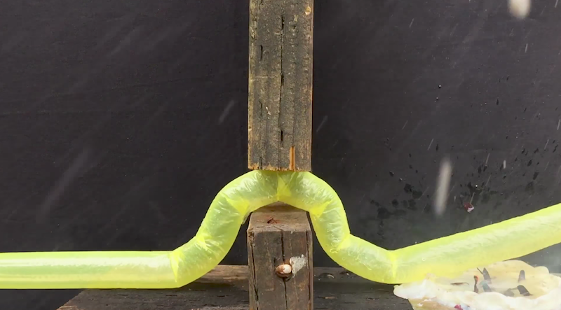 Stanford's snaking robot bending around and between two pieces of wood