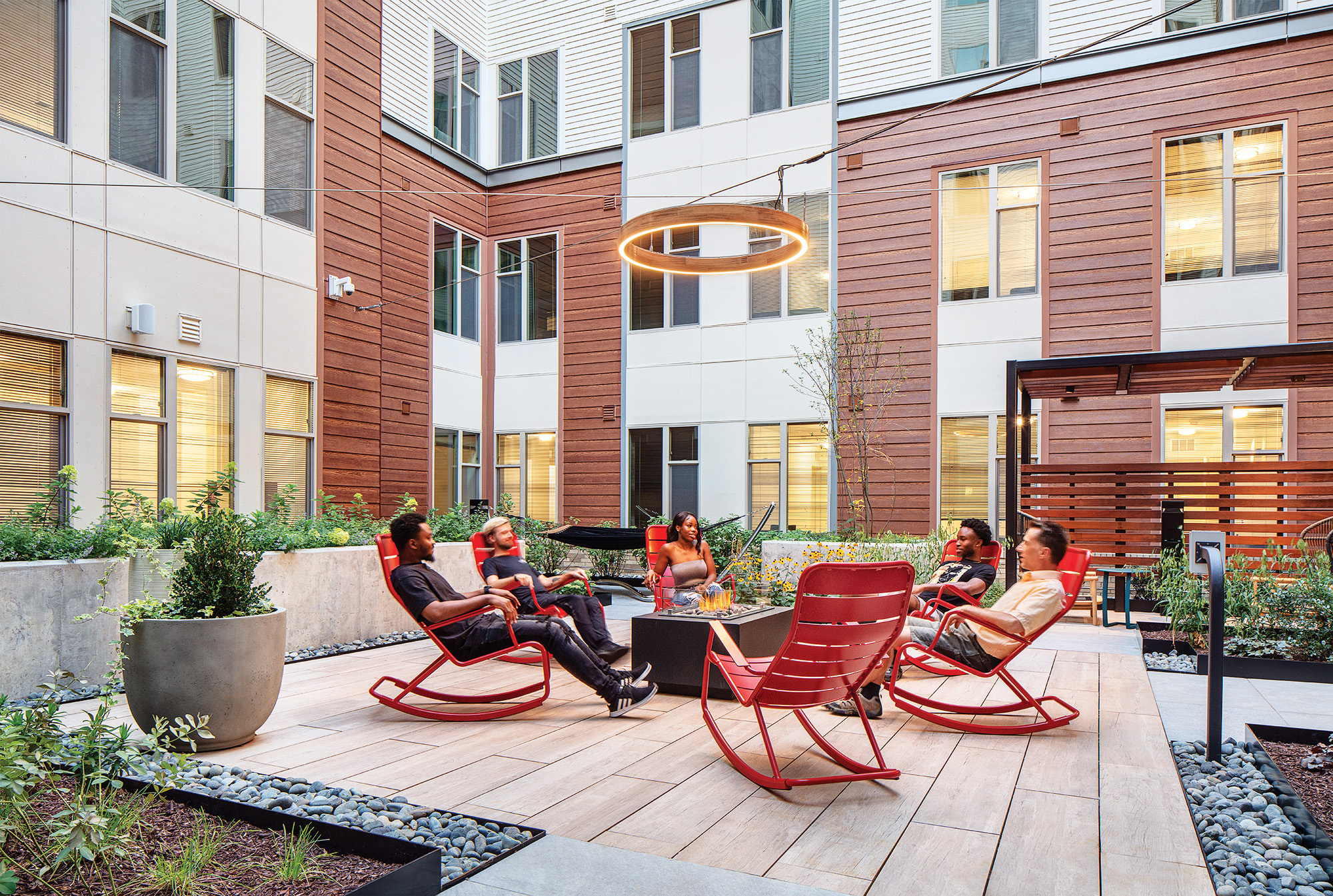 TEMPO student housing, people around a fire pit