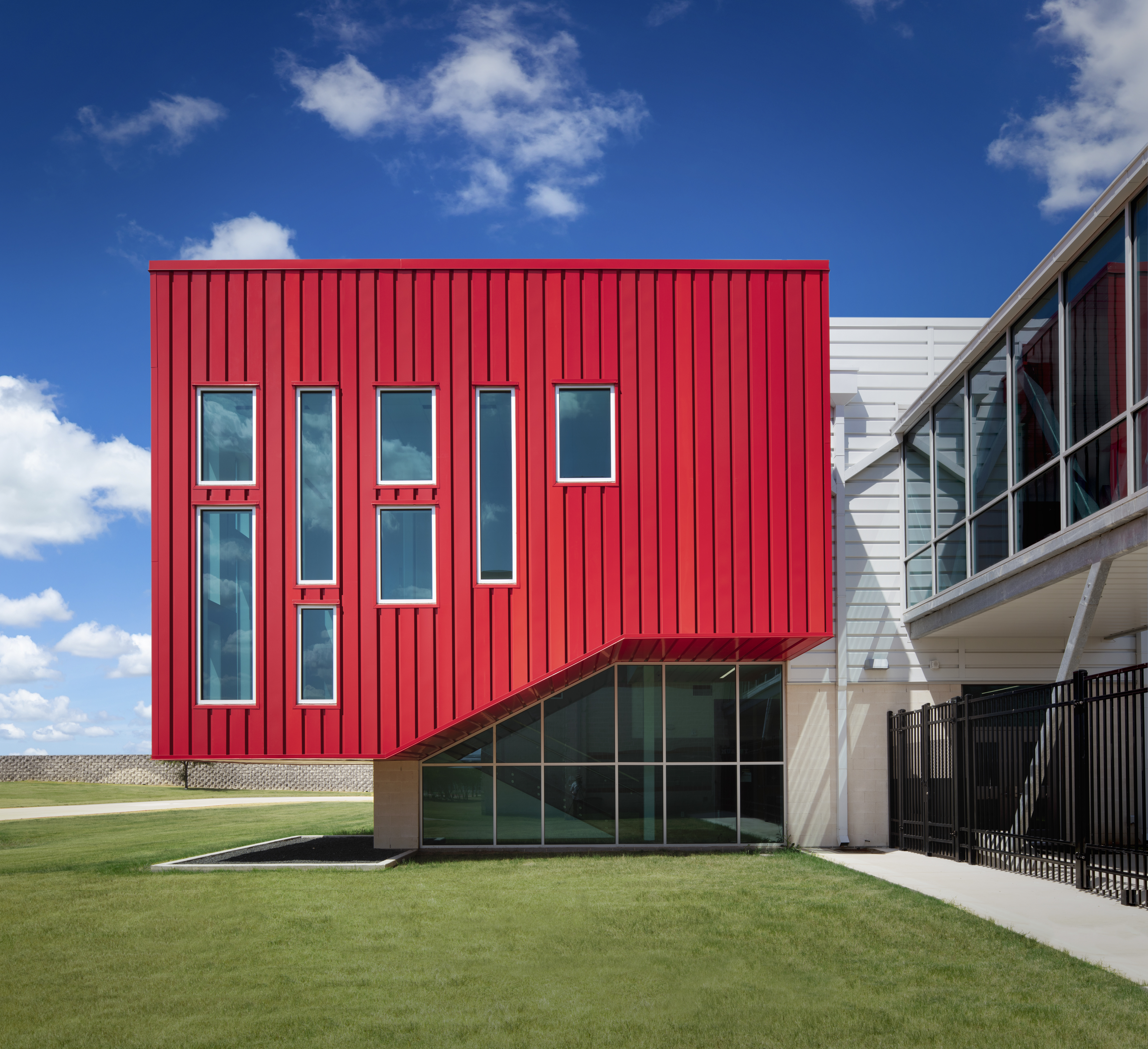 PAC-CLAD Highline S1 metal wall panel system clads Del Valle Career & Tech Center in 3 shades of red