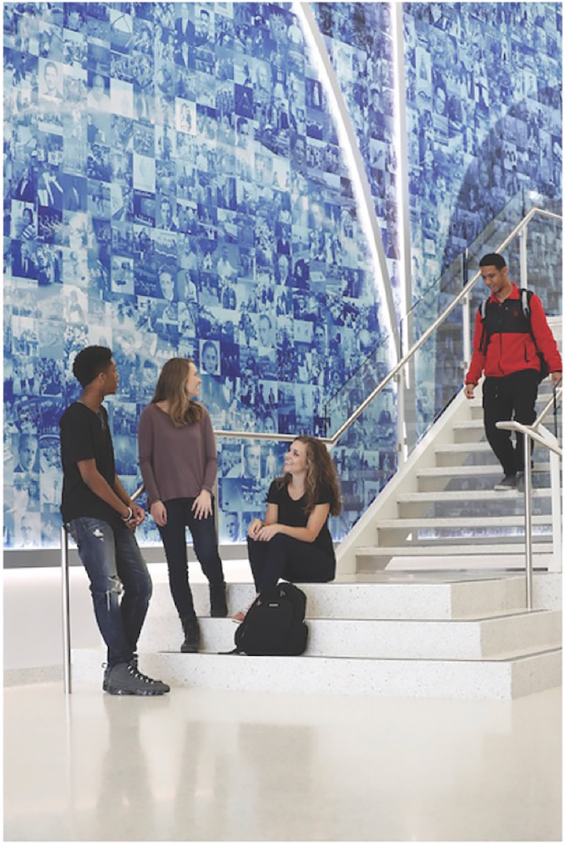 Students gather in front of the Golden Ratio Wall art installation