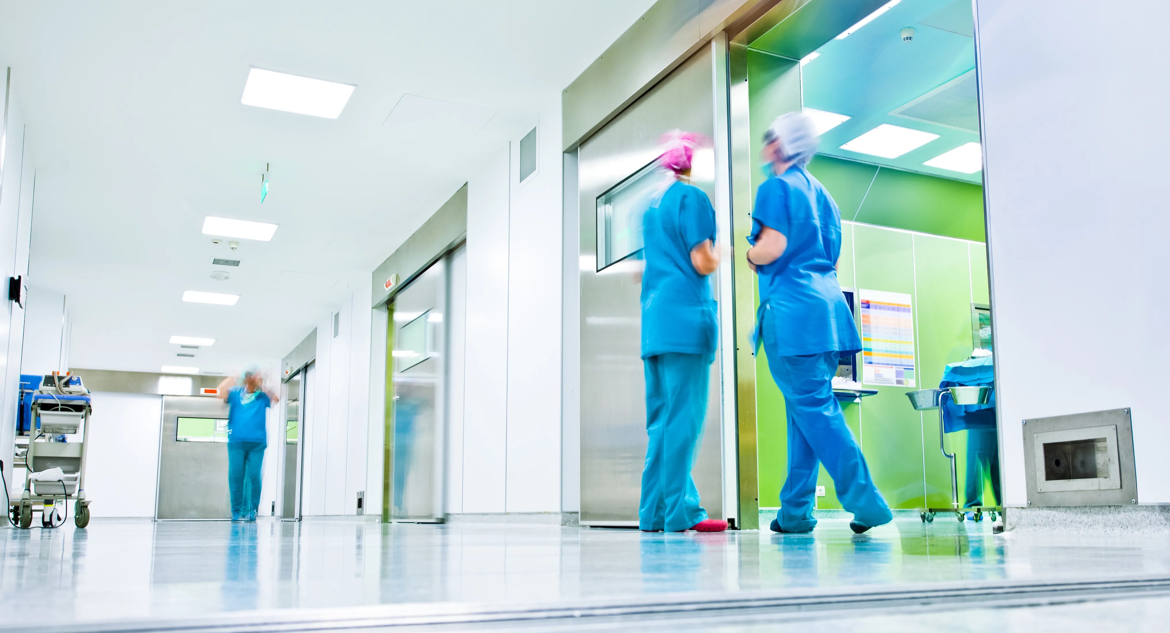 Nurses in bright hospital hallway