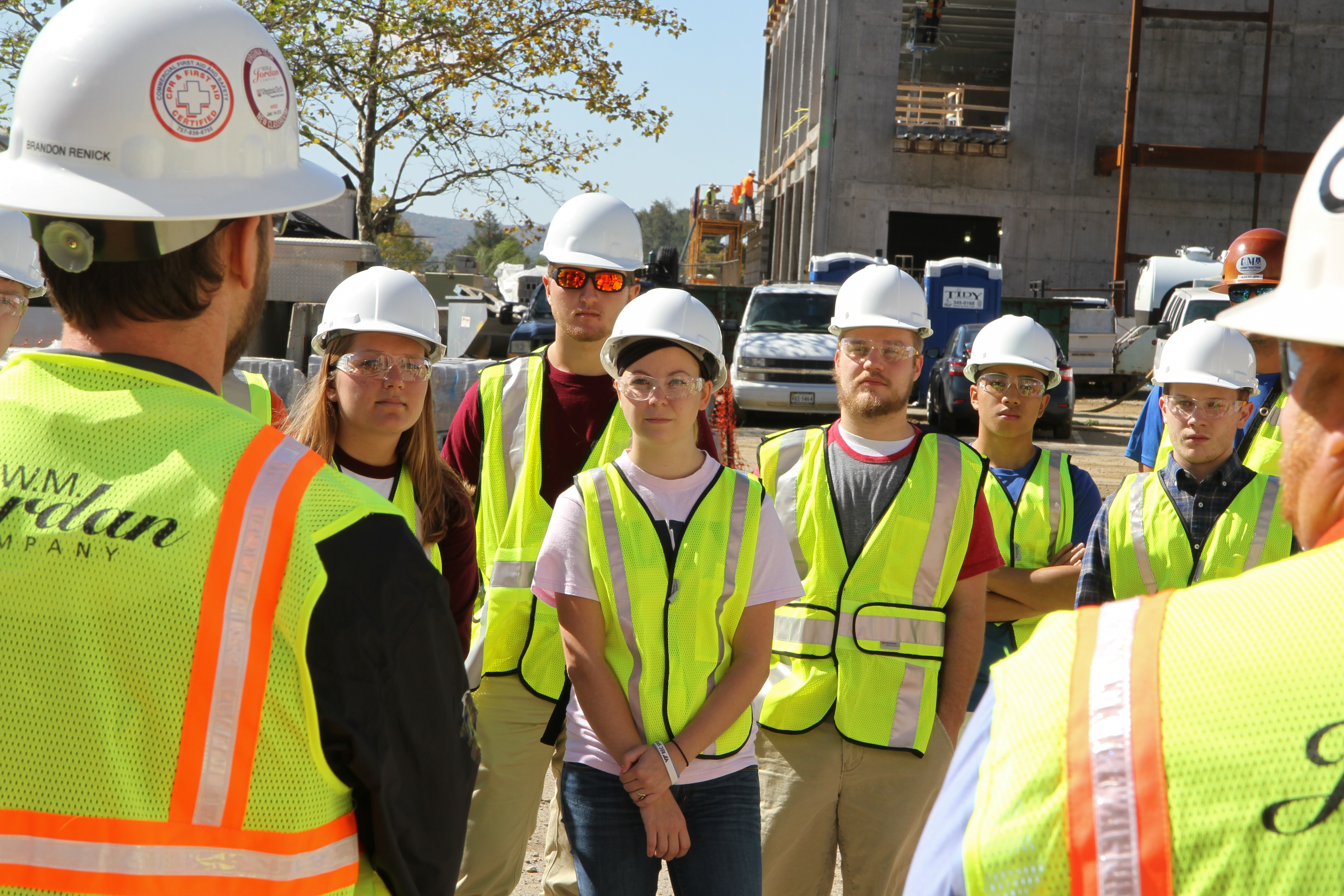 Brendon Renick Assistant Project Manager with W.M. Jordan, leads students on a tour of a  construction site.