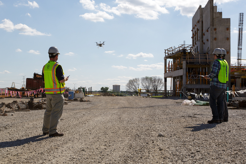 Contractors flying drone at a site