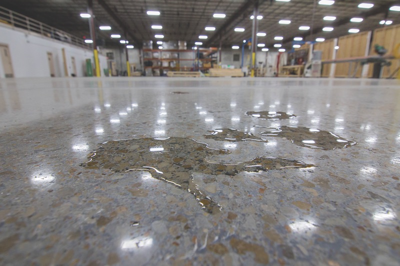 A puddle of water on a concrete floor treated with Concrete Protector SB