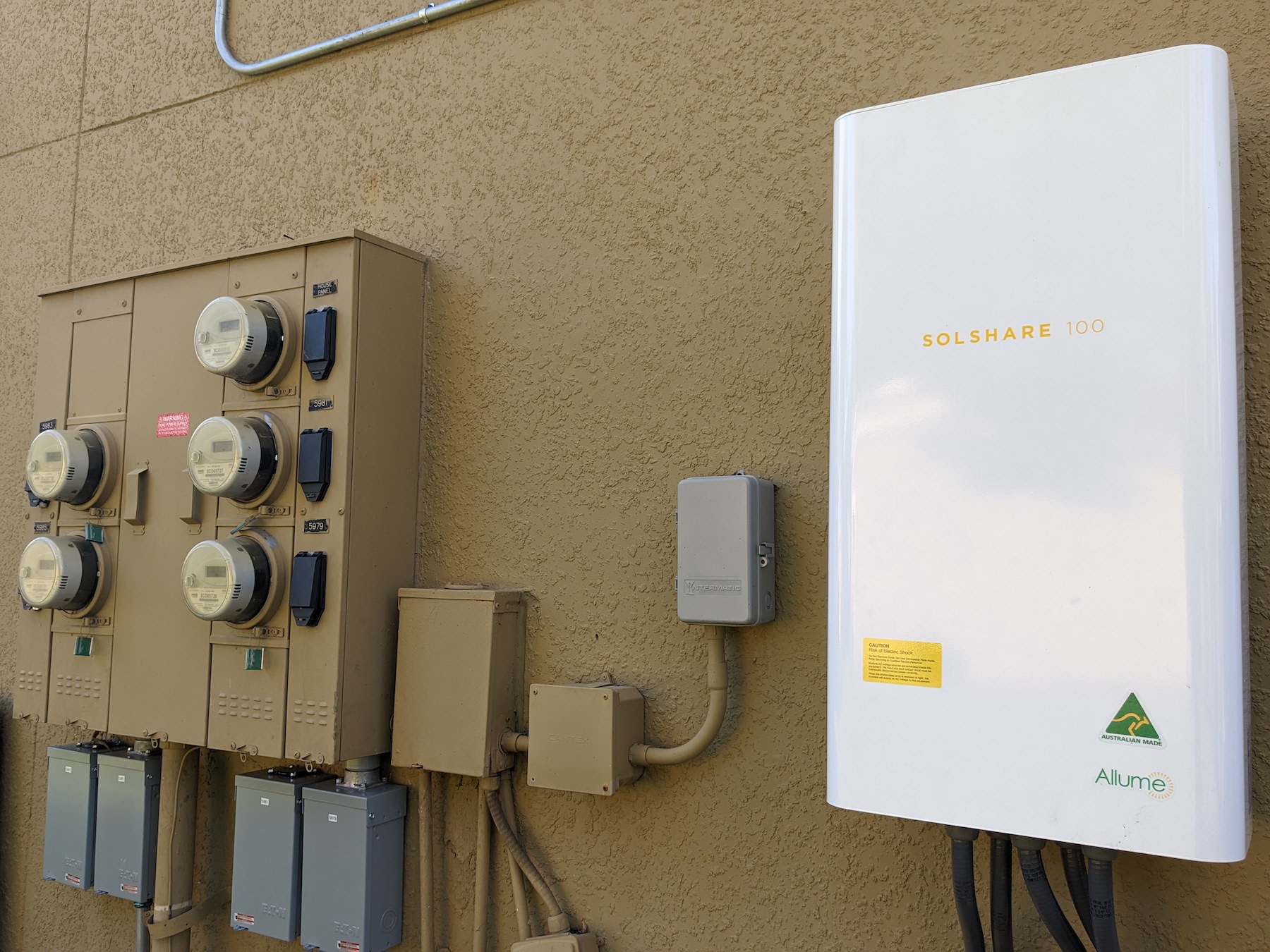 SolShare unit with bank of grid meters. Image credit: Allume Energy