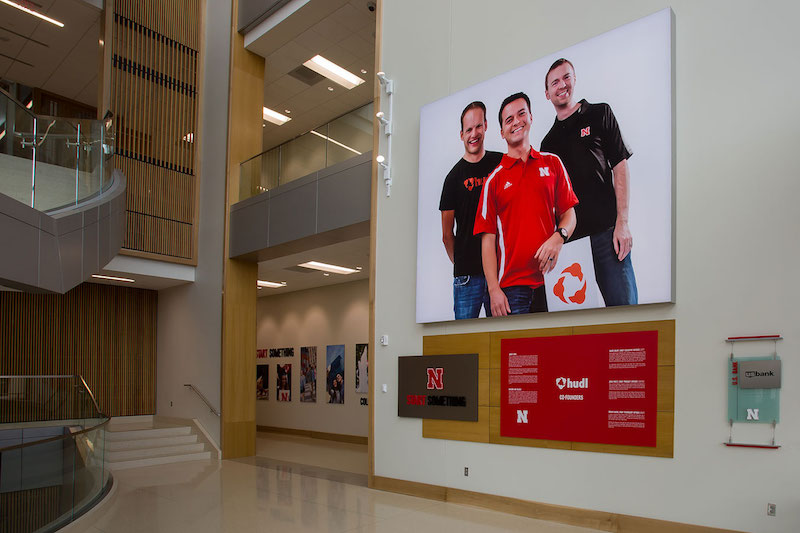 Greeting visitors upon entry in the Henrickson Grand Atrium is a 14-foot tall display featuring the founders of HUDL