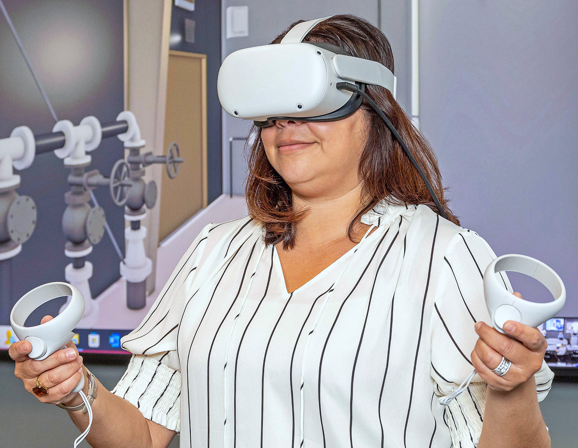 Woman in office setting wearing VR headset