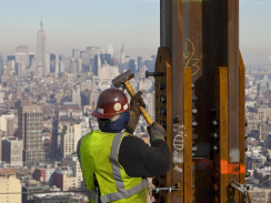 Construction crews set in place a steel horizontal beam at a height (C) CBS News