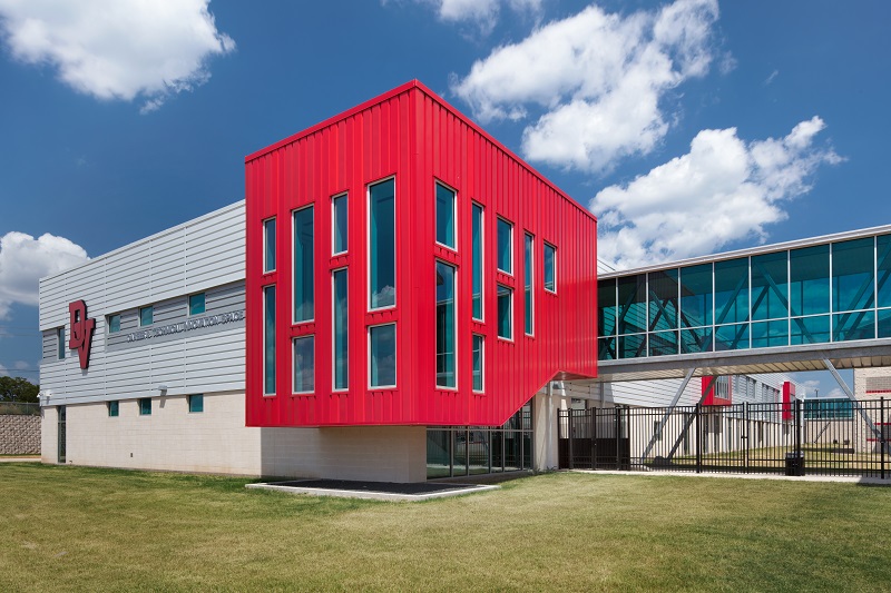 PAC-CLAD Highline S1 metal wall panel system clads Del Valle Career & Tech Center in 3 shades of red