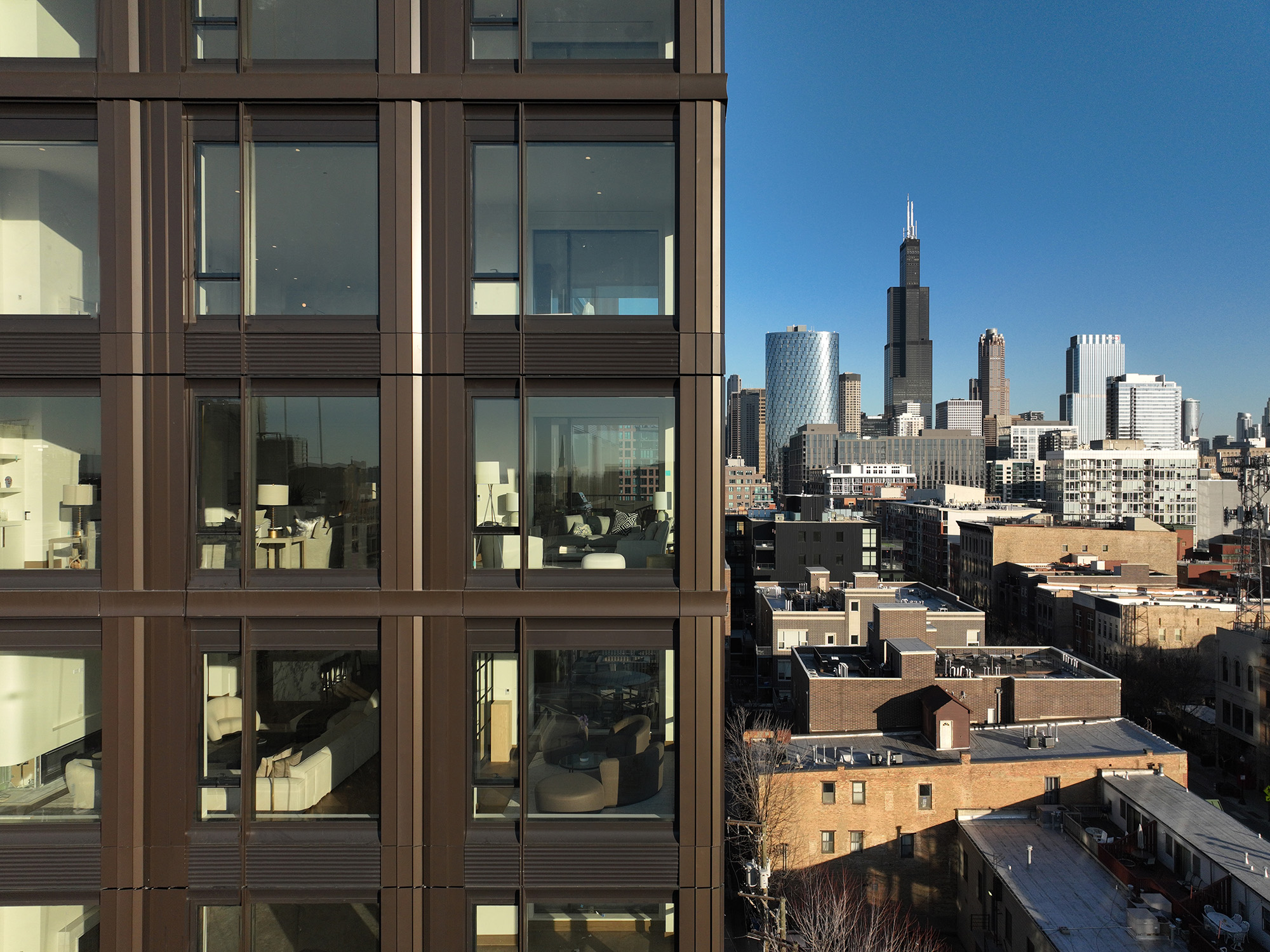 large window openings offer framed views of the surrounding cityscape