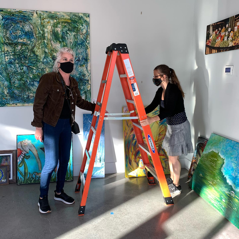 ​UVA technical staff set up the latest showing at Arthaus's gallery.