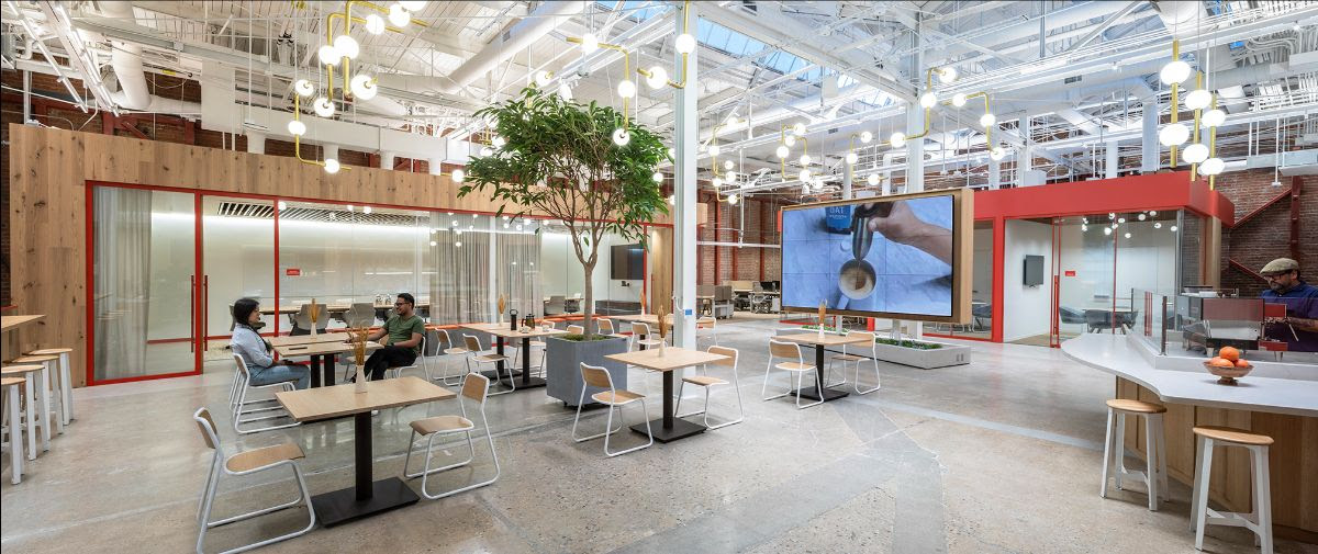 Creating new avenues for in-house operations, the office café is bordered by generous meeting rooms, the café bar and tasting room, and a sizable screen that pilots the company’s digital media. Photo by SLAM.