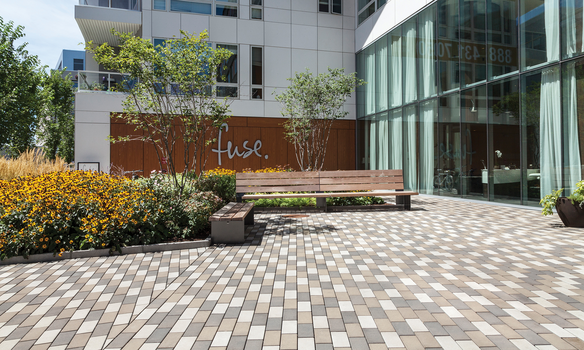 At the Fuse Condominium in Cambridge, Massachusetts, Halvorson Design Partnership selected permeable pavers for the courtyard and two roof decks to support maximum infiltration and enhance the pool, lounging, and dining areas.