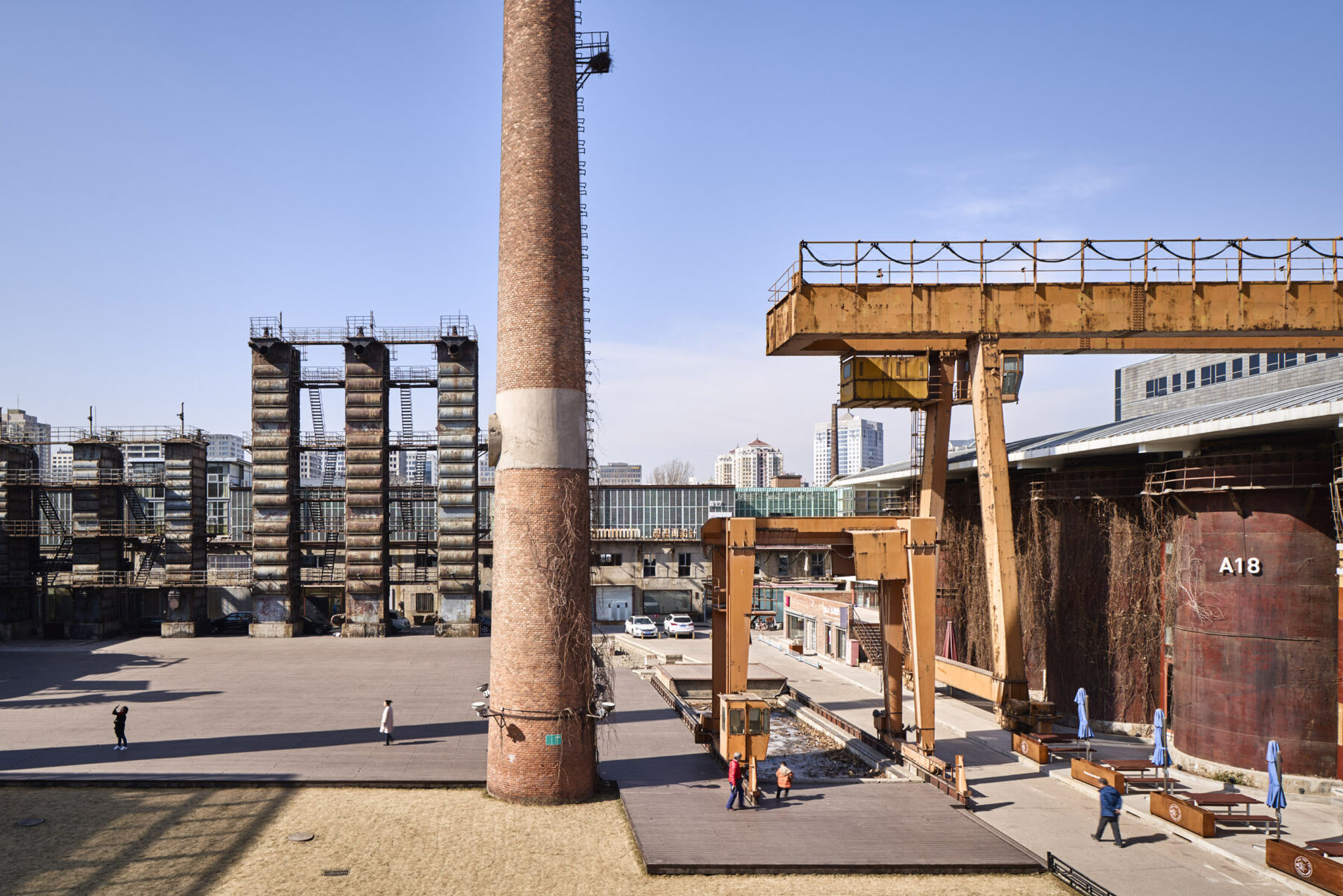 People walking around site with industrial features