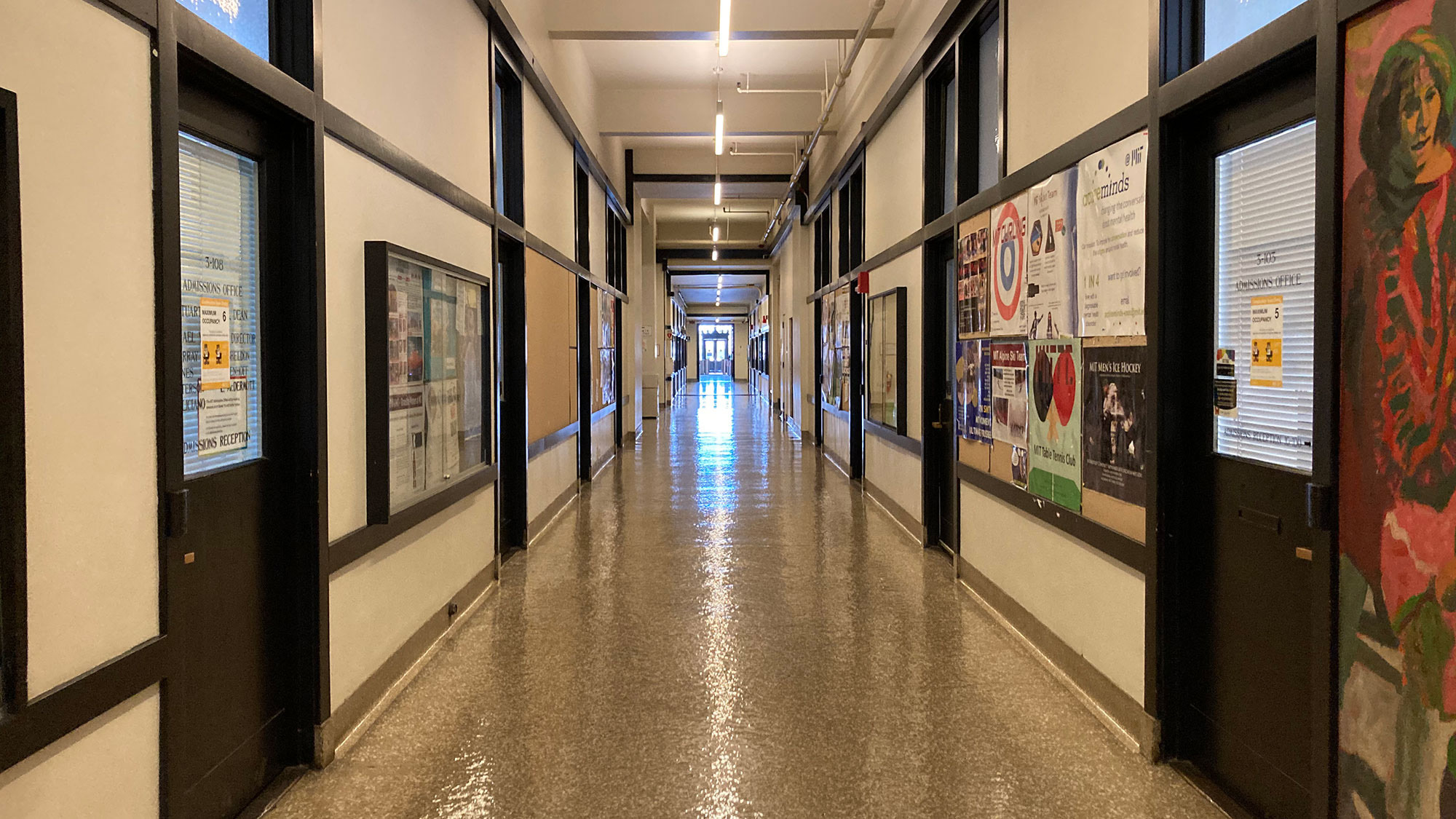The interior of a long hallway corridor at MIT.