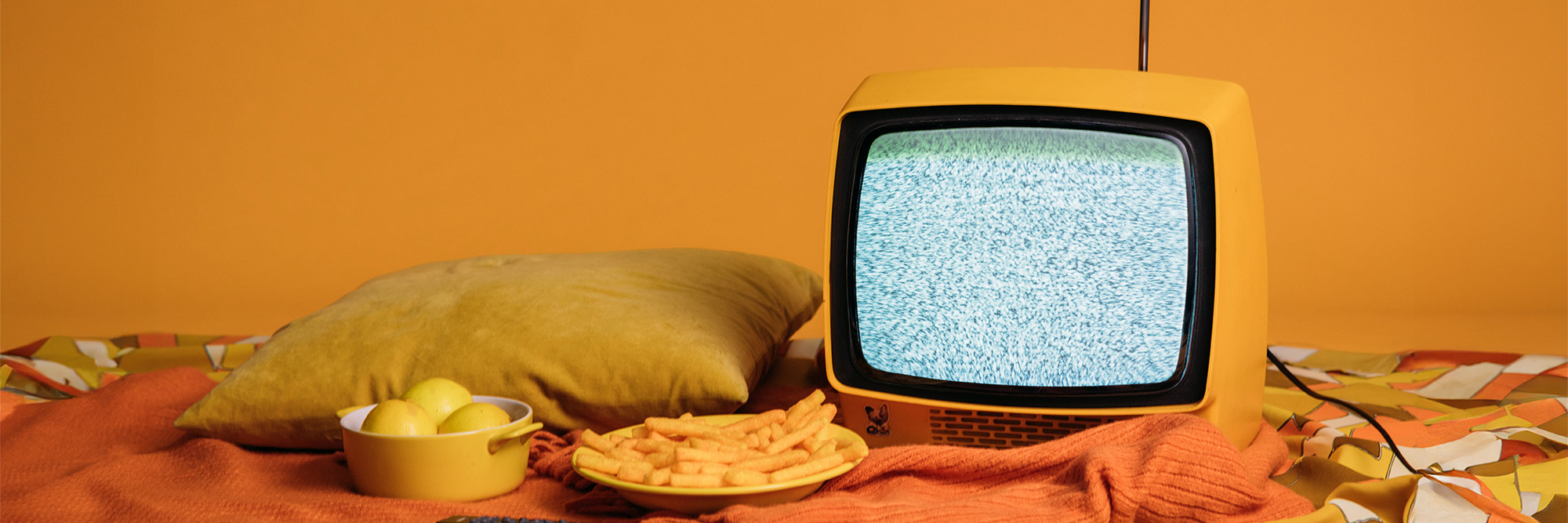 Tv With Blank Scree And Food On Bed