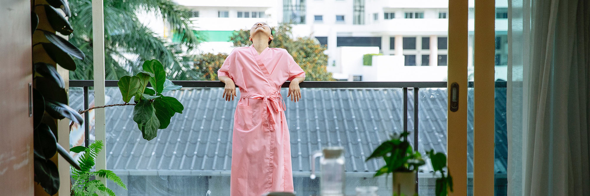Woman standing on balcony and enjoying morning time