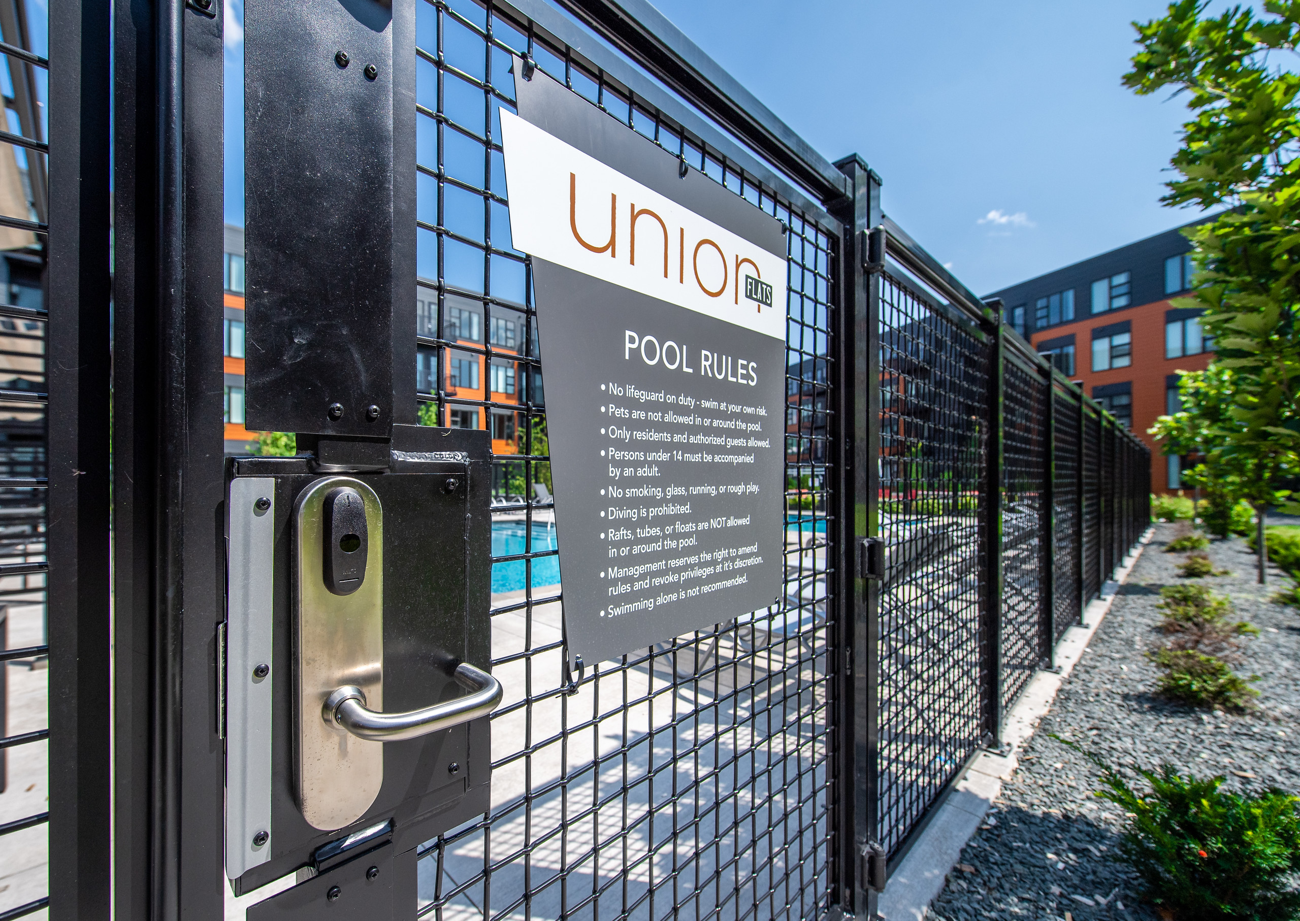 A lock on the apartment pool gate secures amenities for residents.