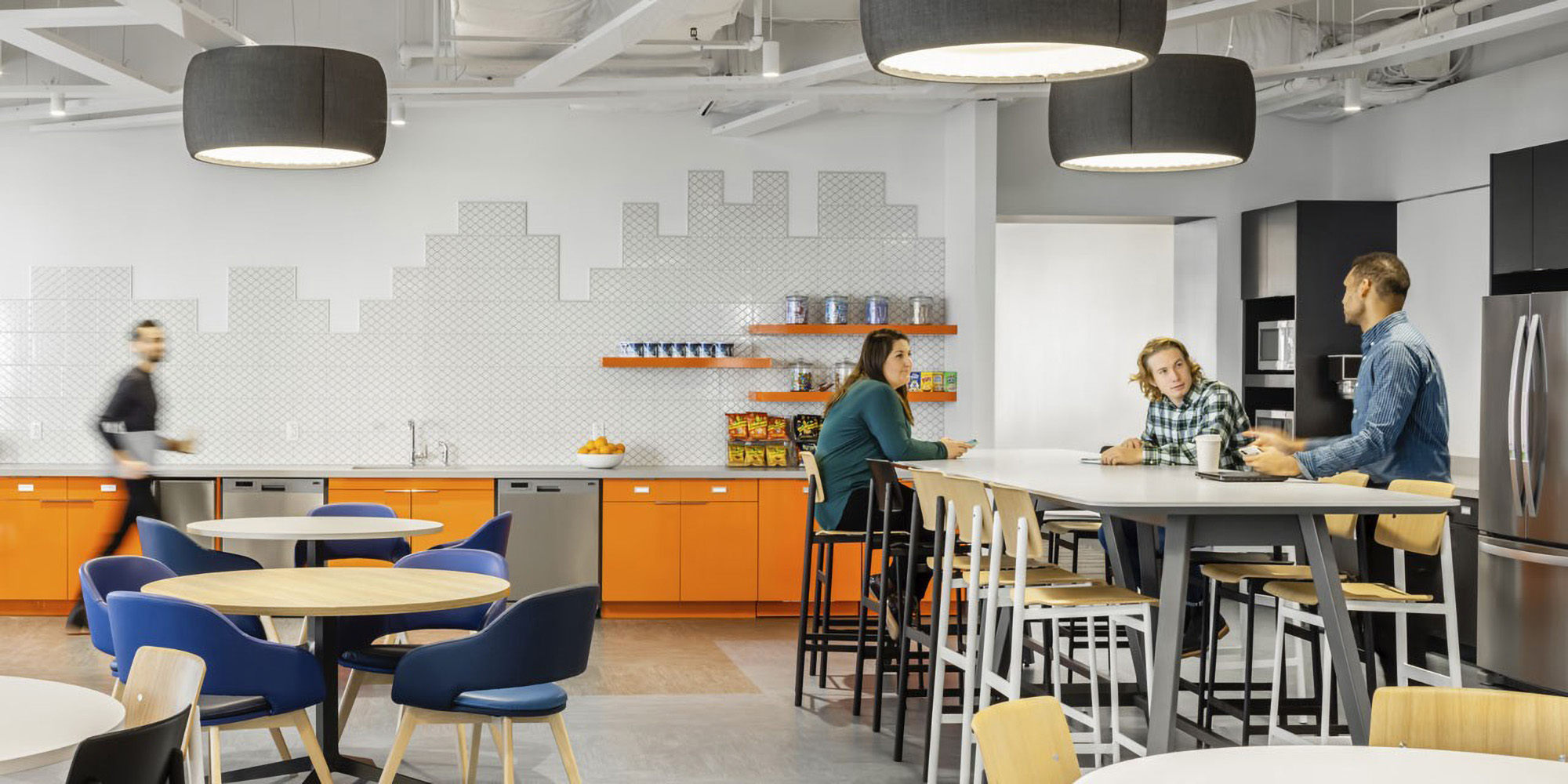 A lively work café with flexible seating at Cambridge Mobile Telematics HQ, designed by SMMA