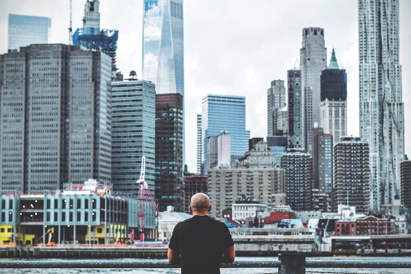 A man standing in front of the New York City skyline