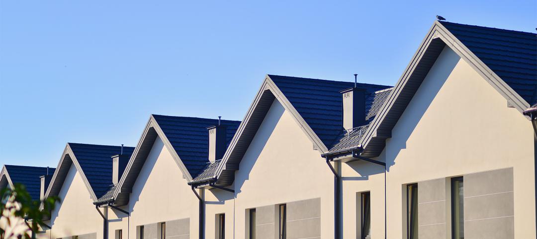 Suburban neighborhood condominium complex geometric family houses against blue sky