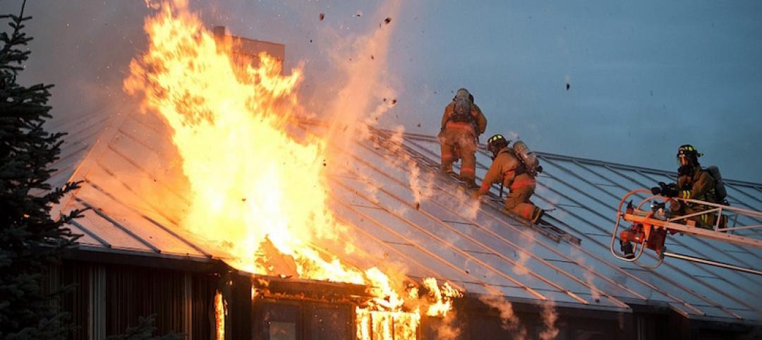 Firefighters on the roof of a burning building in Alaska