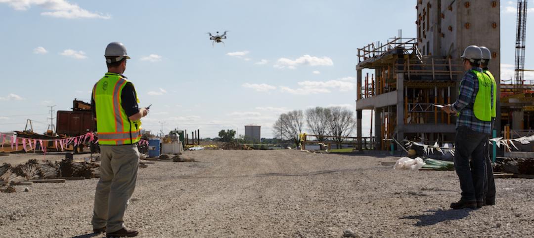 Contractors flying drone at a site