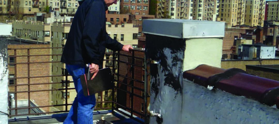 Facilities professional inspects a roof railing system. 