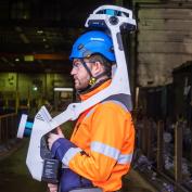 Skanska USA is exploring how AI can intersect with and enhance jobsite automation. Shown here are a Skanska worker using NavViz’s scanner to create digital models.