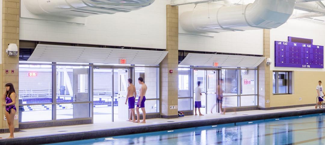 Fire-rated glass separation helps merge new and old pools into a single connected aquatics center